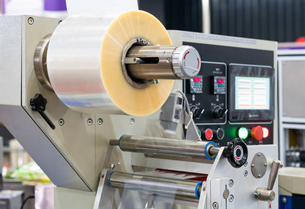 istock Close up transparent plastic stretch film sheet roll on automatic wrapping or packing machine for goods or product etc. in industrial 1449081585