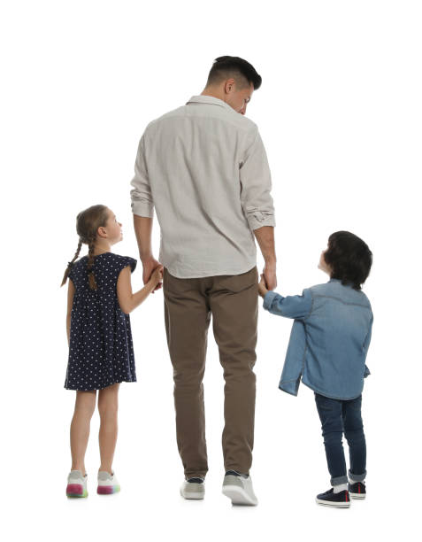 children with their father on white background, back view - primary care imagens e fotografias de stock