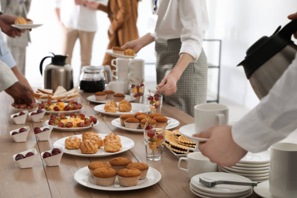 istock People near table with different delicious snacks during coffee break, closeup 1449082237
