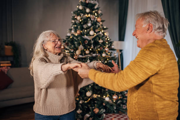istock Senior couple dancing at home on Christmas 1449082517
