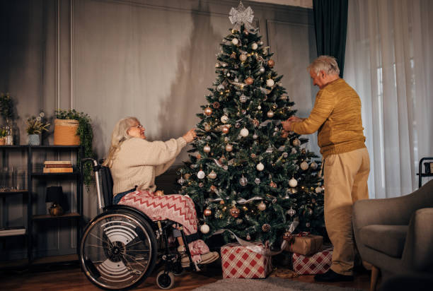 istock Senior couple decorating Christmas tree at home 1449083381