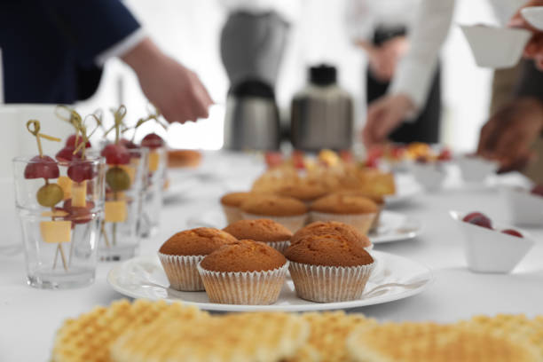 istock People near table with different delicious snacks during coffee break, closeup 1449083984
