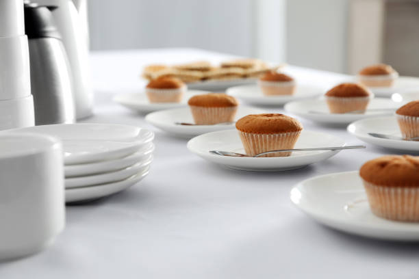 istock Many delicious muffins served on white table for coffee break 1449084438