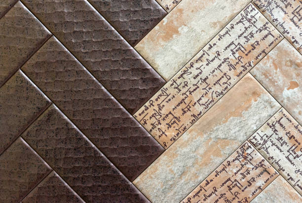istock Brown and beige ceramic tiles with letters laid out in a herringbone pattern. 1449084605