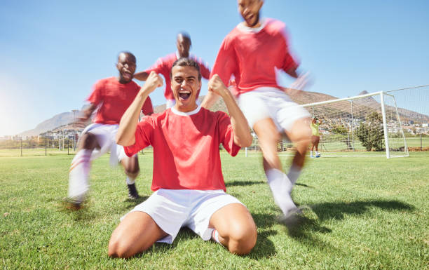 man, soccer and team winner in celebration for sports victory, score or goal on the field outdoors. happy male football players celebrating win, teamwork or achievement together in fitness on grass - soccer celebration success group of people imagens e fotografias de stock