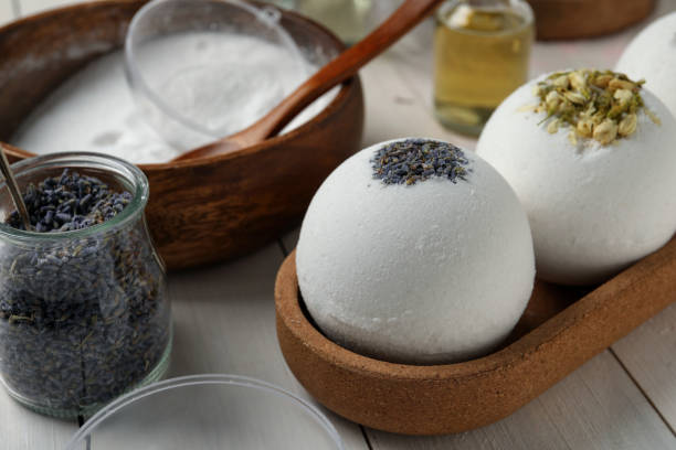istock Different bath bombs and ingredients on white wooden table, closeup 1449086282