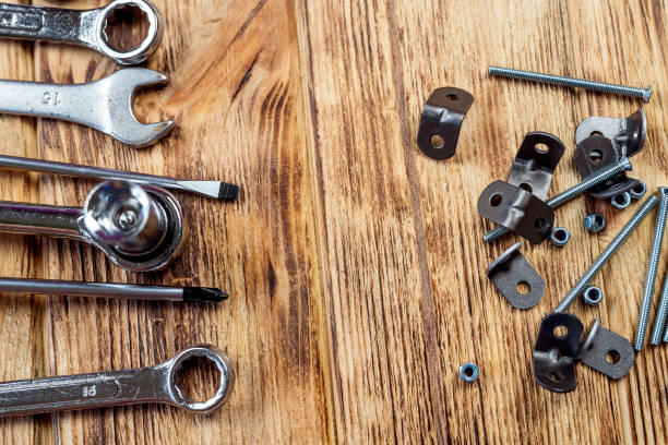 istock Furniture assembly tools set with screw dowel wrench and bolt on wooden table texture. 1449086828