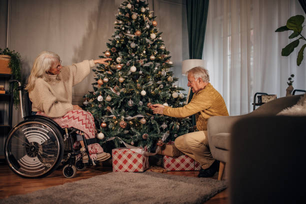 istock Senior couple decorating Christmas tree at home 1449087274