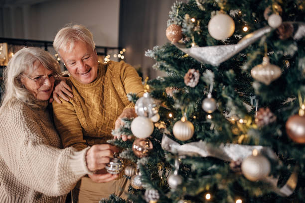 istock Senior couple decorating Christmas tree at home 1449087425