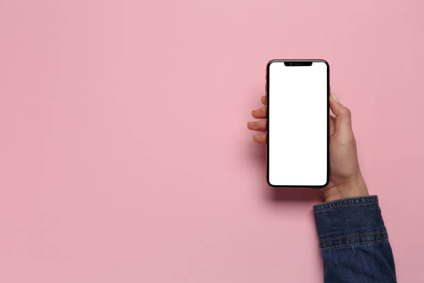 istock Woman with smartphone on pink background, top view. Space for text 1449087552