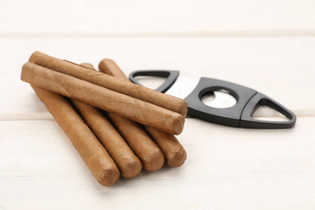 istock Cigars and guillotine cutter on white wooden table 1449087724