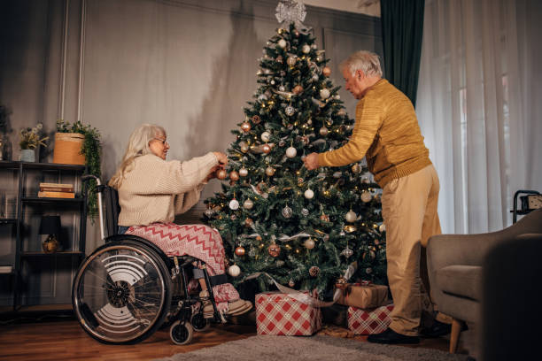 istock Senior couple decorating Christmas tree at home 1449088471