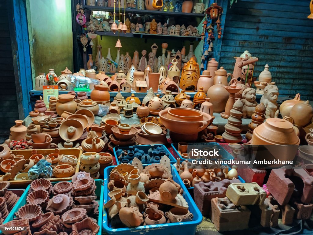 Stock photo of clay made pots, oil lamps, decorative items, animals, lantern, traditional stove idols, kept on street for sale in the local market area at Kolhapur, Maharashtra India.focus on object Animal Stock Photo