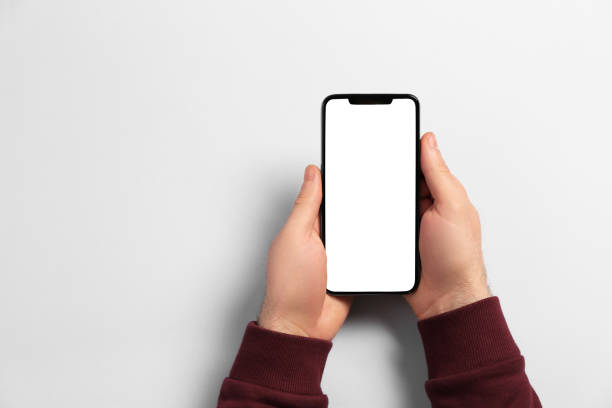 istock Man with smartphone on light grey background, top view. Space for text 1449089141