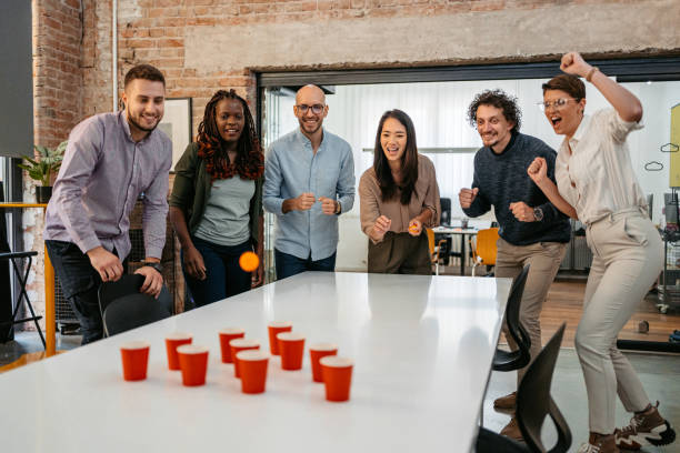 istock Colleagues Playing Beer Pong At The Office 1449089368