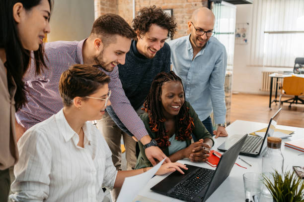 istock Colleagues Watching Something On Laptop While At The Office 1449089434