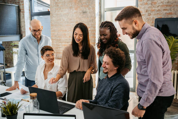 istock Colleagues Watching Something On Laptop While At The Office 1449090282