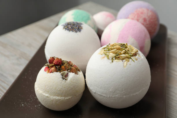 istock Plate with different bath bombs on wooden table, closeup 1449090339