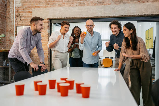 istock Colleagues Playing Beer Pong At The Office 1449090613