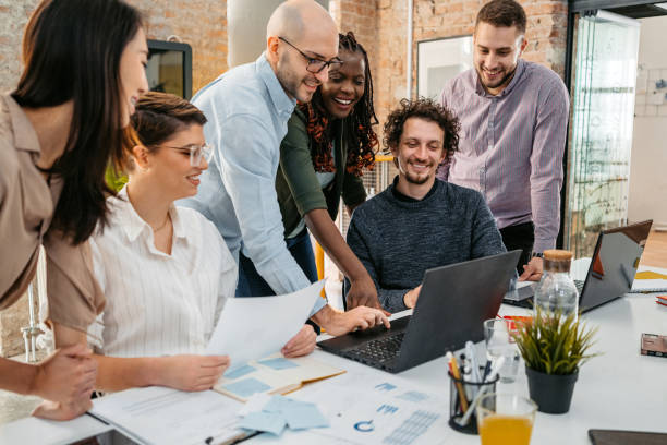 istock Colleagues Watching Something On Laptop While At The Office 1449090725