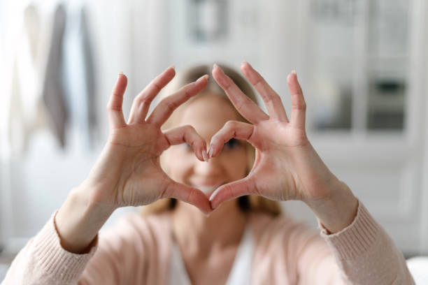 istock Woman showing heart shape gesture, selective focus on hands 1449090782