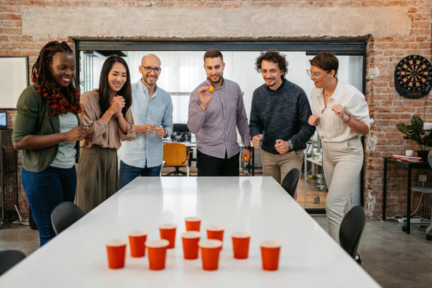 istock Colleagues Playing Beer Pong At The Office 1449090843
