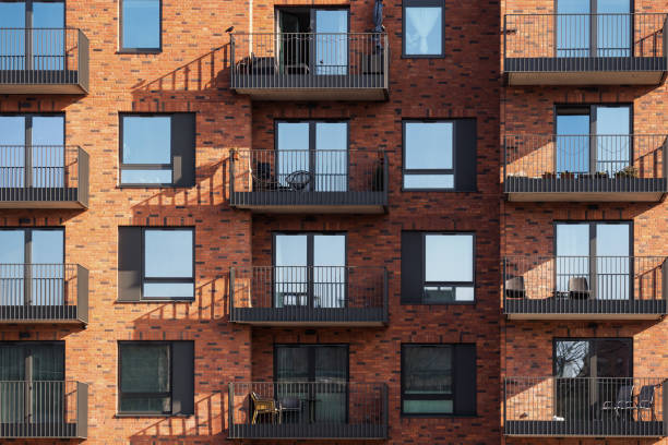 istock Front view of new building with metal window frames and open balcony 1449090856
