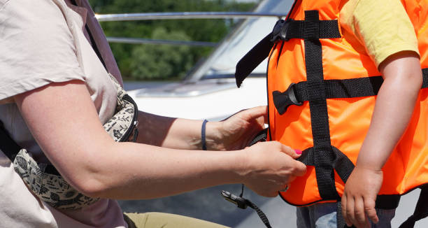 istock Mother Helping the son with a life vest jacket. 1449091347