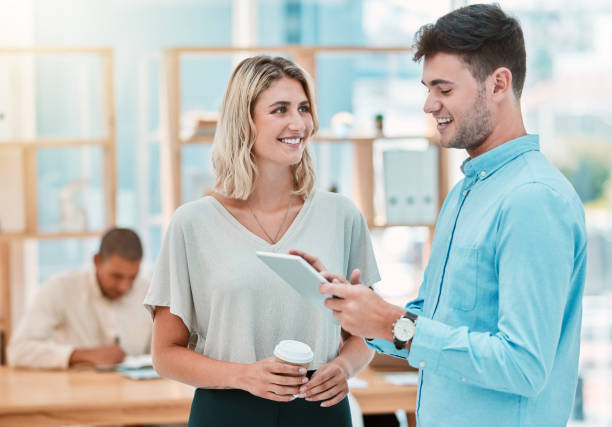 istock Corporate, smile and employees talking with a tablet, planning and working on the internet together at work. Happy, young and business workers speaking about a project online with technology 1449091499