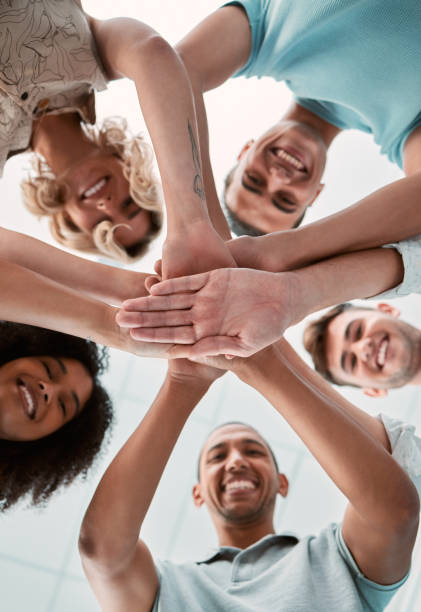 istock Hands together, support and teamwork people for business collaboration, team building and work motivation. Happy group of people stacked sign for mission, community trust and diversity success below 1449091593