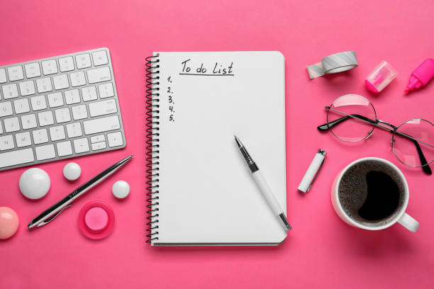 istock Flat lay composition with unfilled To Do list, computer keyboard and cup of coffee on pink background 1449091731