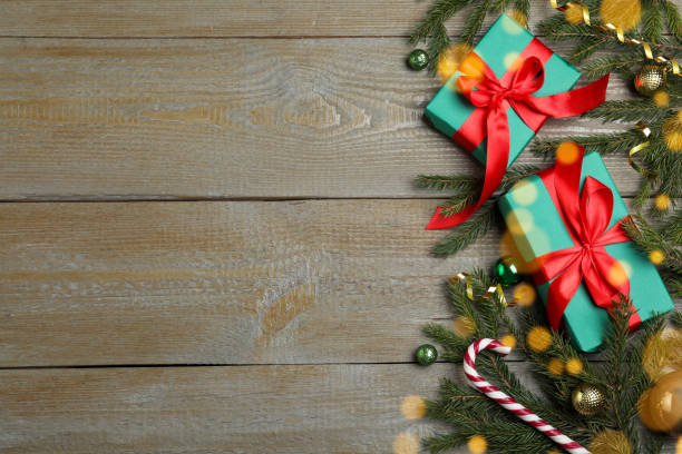 istock Christmas greeting card with space for text. Flat lay composition of fir tree branches and festive decor on wooden background 1449092934
