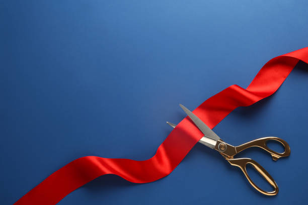 istock Red ribbon and scissors on blue background, top view. Space for text 1449093476