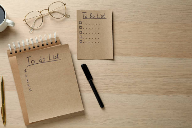 istock Flat lay composition with unfilled To Do lists and glasses on wooden table. Space for text 1449093487