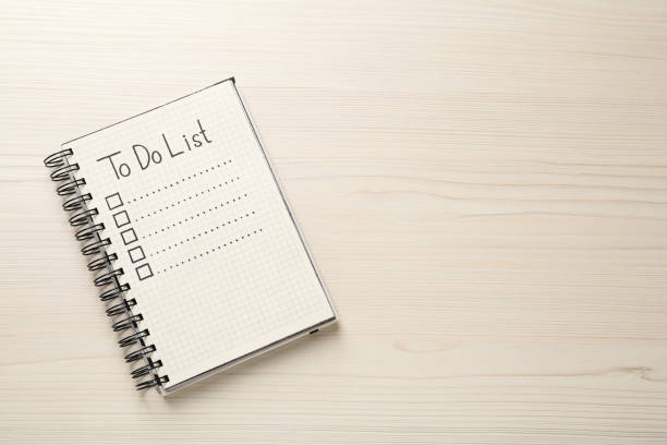 istock Notepad with unfilled To Do list and checkboxes on wooden table, top view. Space for text 1449093518