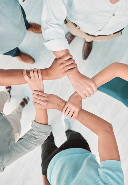istock Business team, hands and teamwork collaboration together in shape from above. Corporate men support, trust and hope motivation success working in office, unity, commitment and union care 1449096446