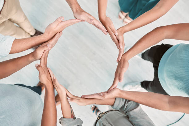 istock Team building, support and business people with hands in a circle for partnership, collaboration and teamwork at work. Corporate workers with a mission, community or solidarity for trust from above 1449096695