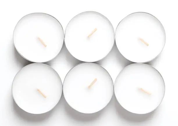 Group of maxi tealights, long-burning tea lights, large tea candles, also known as nightlights. Tea lites, t-lites or t-candles in thin metal cups, so that the wax can liquefy completely while lit.