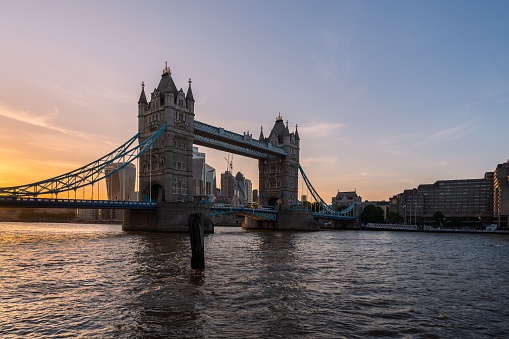 A scenic shot of the Tower Bridge and the city skyline in London, Europe during sunset