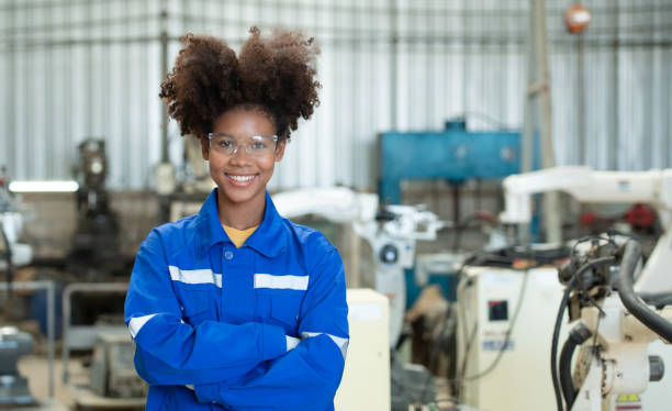 istock Young female engineers are manipulating a welding robot hand. By combining welding manipulation with a control panel for precise welding control. 1449104748