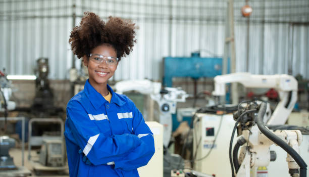 istock Young female engineers are manipulating a welding robot hand. By combining welding manipulation with a control panel for precise welding control. 1449104758