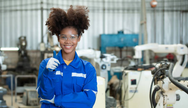 istock Young female engineers are manipulating a welding robot hand. By combining welding manipulation with a control panel for precise welding control. 1449104768