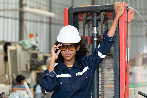 Portrait of a young female engineer in the welding robot industry, posed like a top model.