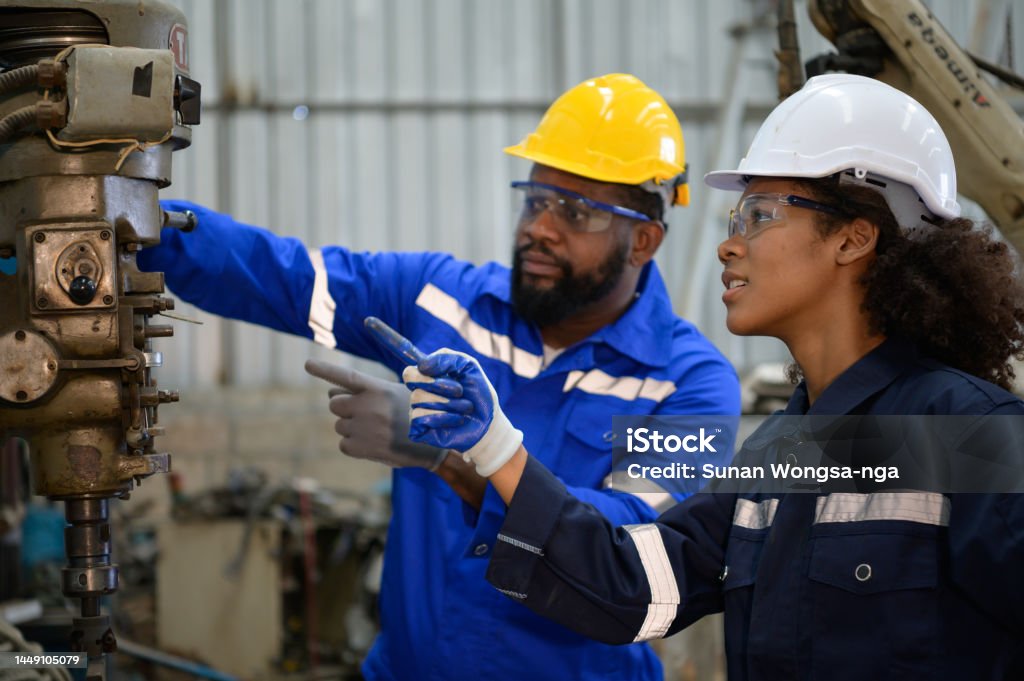 Both of engineers are consulting and exchanging repair experience with each other. Both of engineers are consulting and exchanging repair experience with each other. about repairing old machines to return to normal operation. Trainee Stock Photo