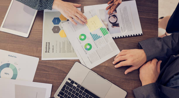istock Top view, hands or laptop with chart documents, infographic research or startup proposal budget. Business people, technology or data analysis paper of company finance or creative marketing accounting 1449106494