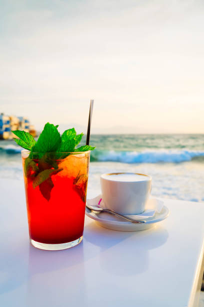 seaside cafe at Mykonos island with cafe and mojito drink, Greece at summer, toned