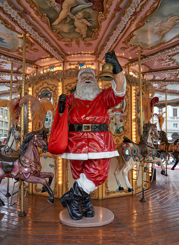 Florence, Tuscany Italy - December 12, 2022 Larger then life-size Santa figure saluting from a carousel.