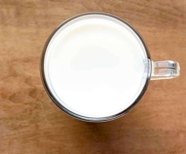 istock a cup of milk on a wooden table 1449112747