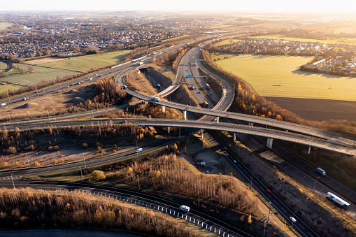 Ferrybridge, Yorkshire, UK - December 14, 2022.  An aerial view above a complex motorway junction with slip roads and overbridges connecting the M62 and A1 motorways in the UK