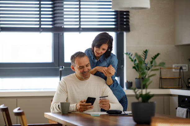 istock Lovely couple using laptop for online shopping. 1449117073